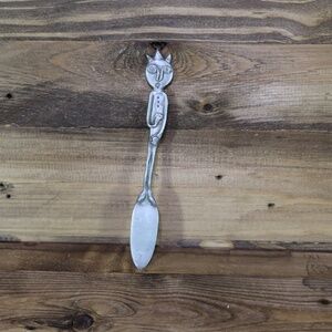 Vtg metal pewter tone spike hair man spreader stir serving folk art signed Oliv